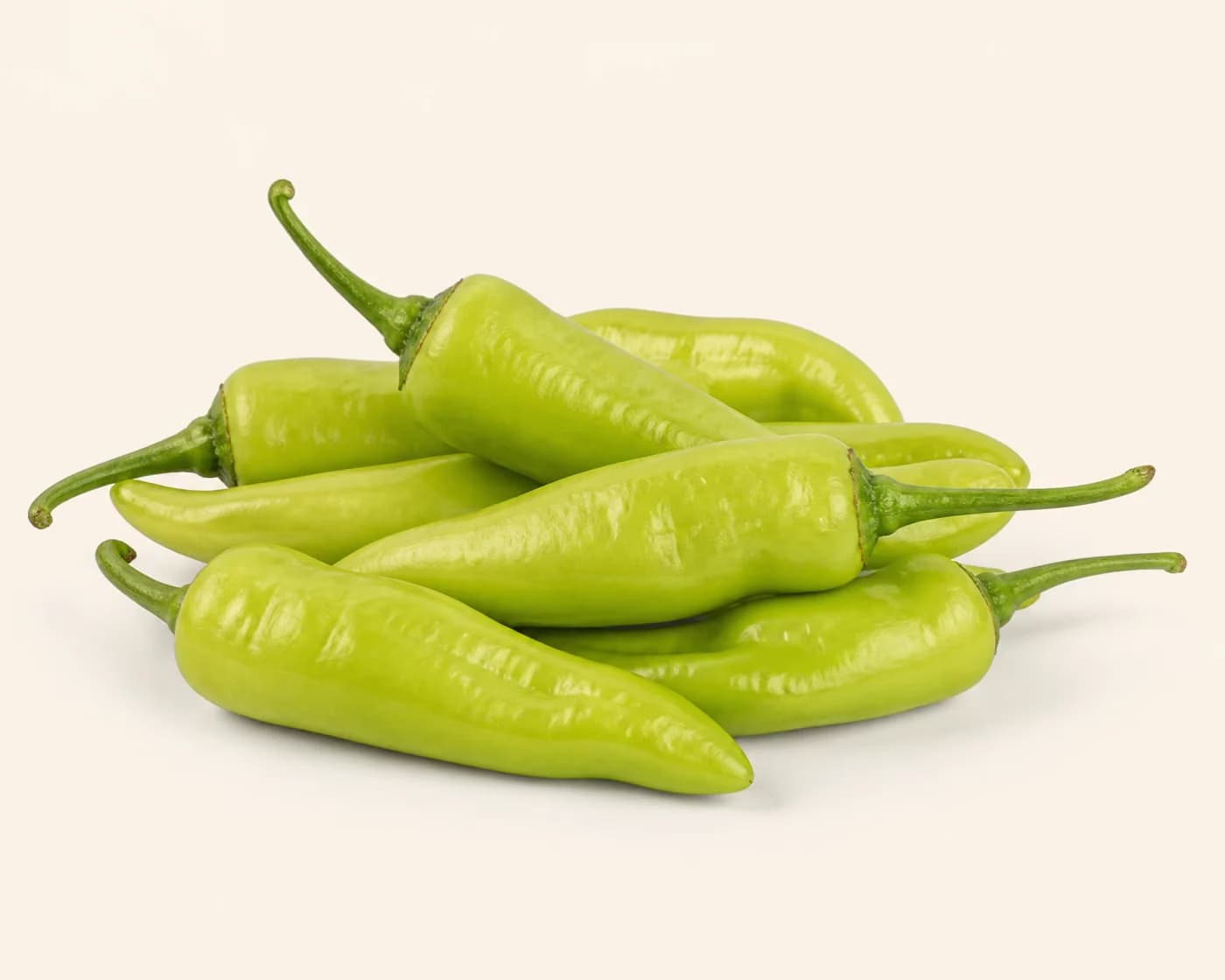 Fresh Bhavnagri Chilli arranged on a warm off-white surface.