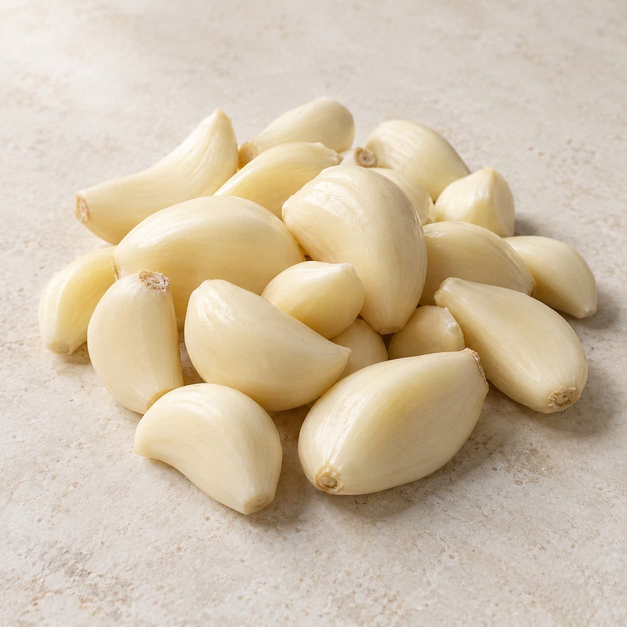 Illustrative peeled ivory garlic cloves on a cream surface.