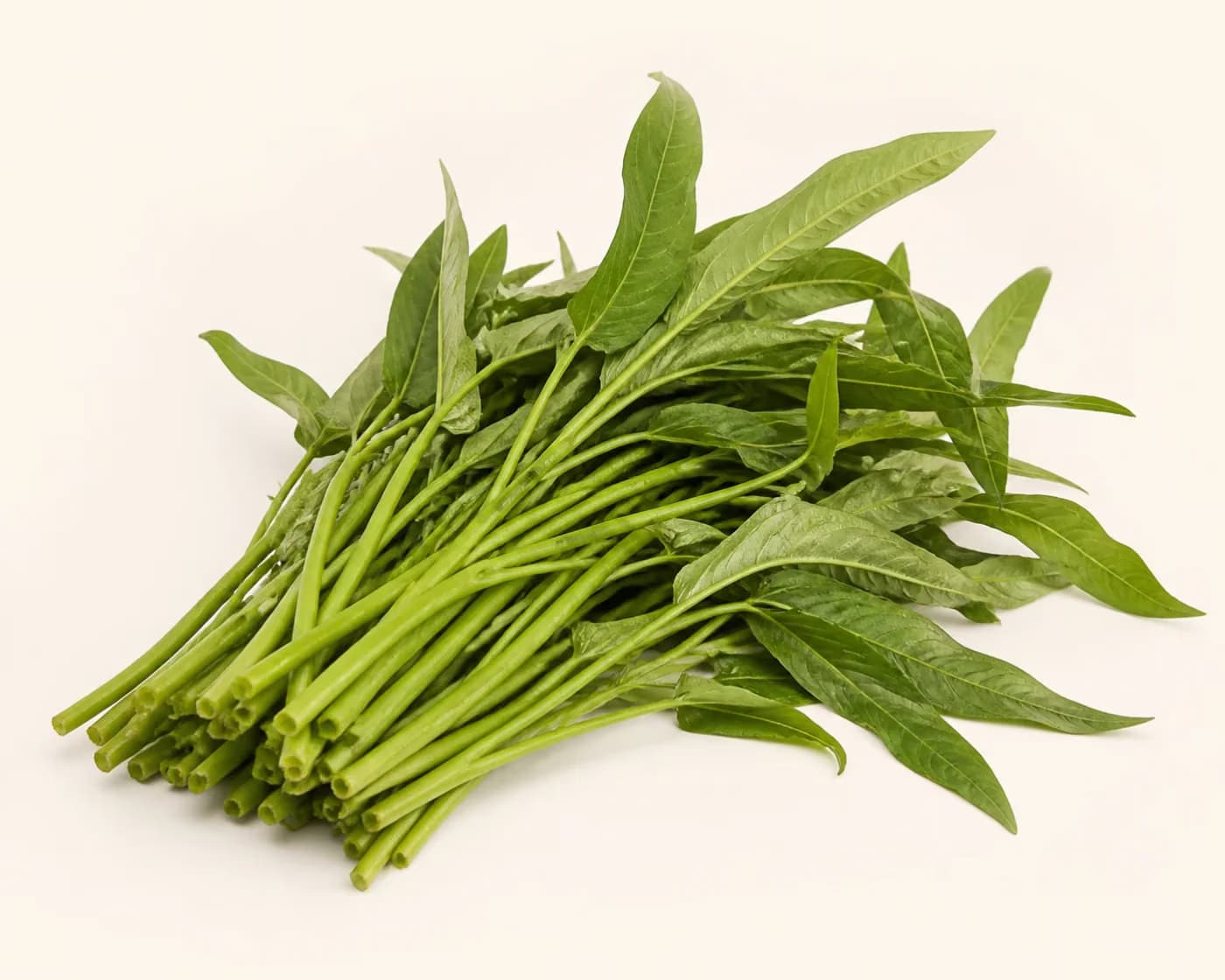 Fresh Water Spinach arranged on a warm off-white surface.