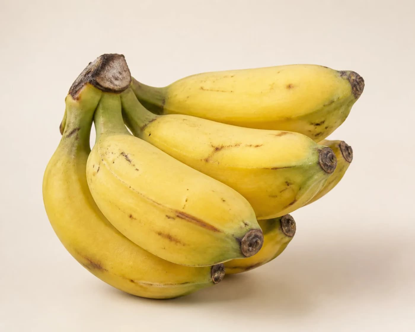 Fresh Robusta Banana arranged on a warm off-white surface.