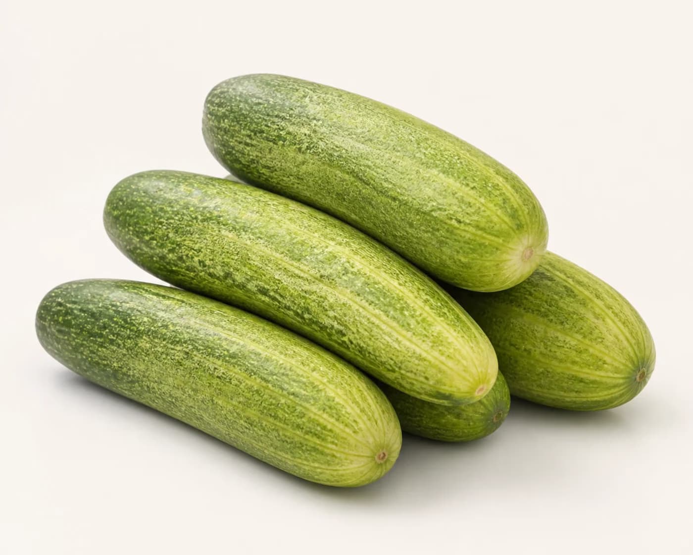 Fresh Desi Cucumber arranged on a warm off-white surface.