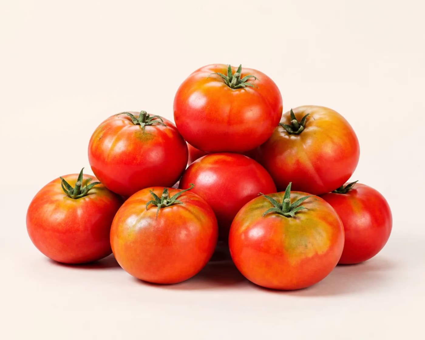 Fresh Desi Tomato arranged on a warm off-white surface.