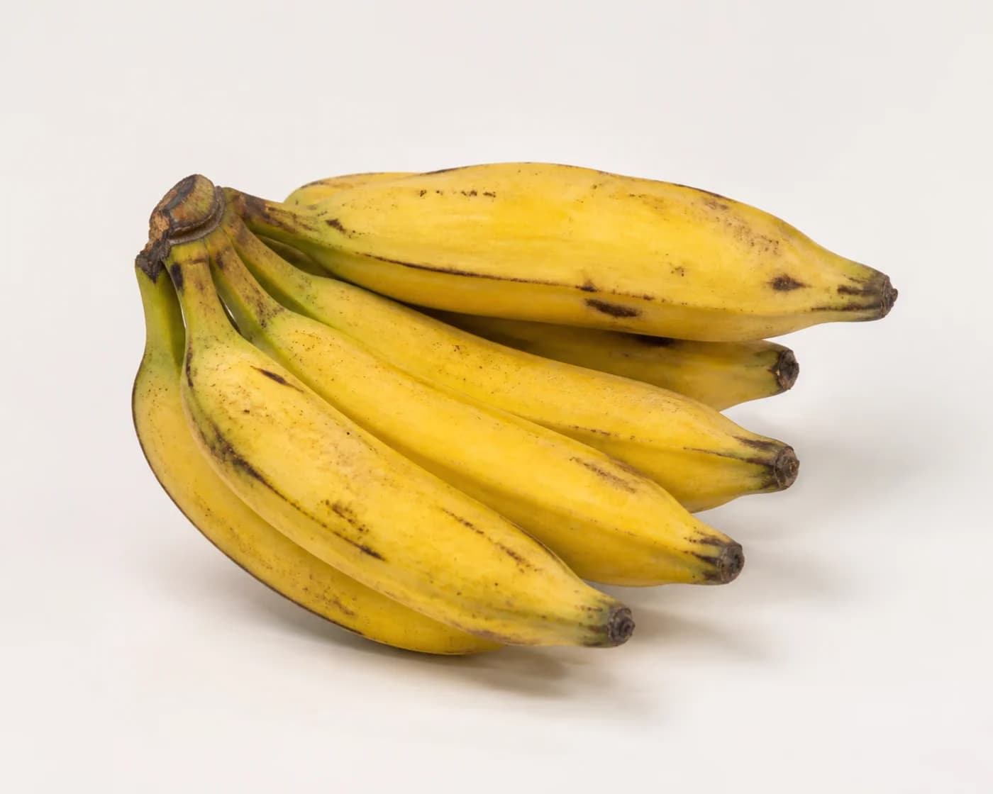 Fresh Nendran Banana arranged on a warm off-white surface.