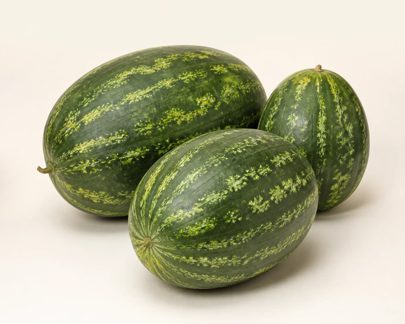 Fresh Rajasthan Desi Watermelon arranged on a warm off-white surface.